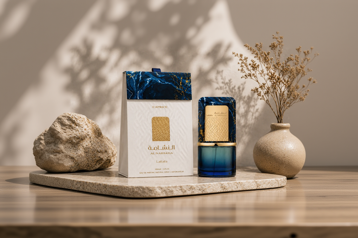 A luxury fragrance bottle and its outer packaging box, both featuring a blue marble pattern and gold accents, displayed on a stone pedestal with decorative props.